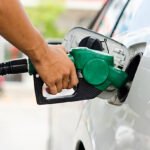 Refueling Car With Gasoline Pump Nozzle, Selective Focus on pump nozzle
